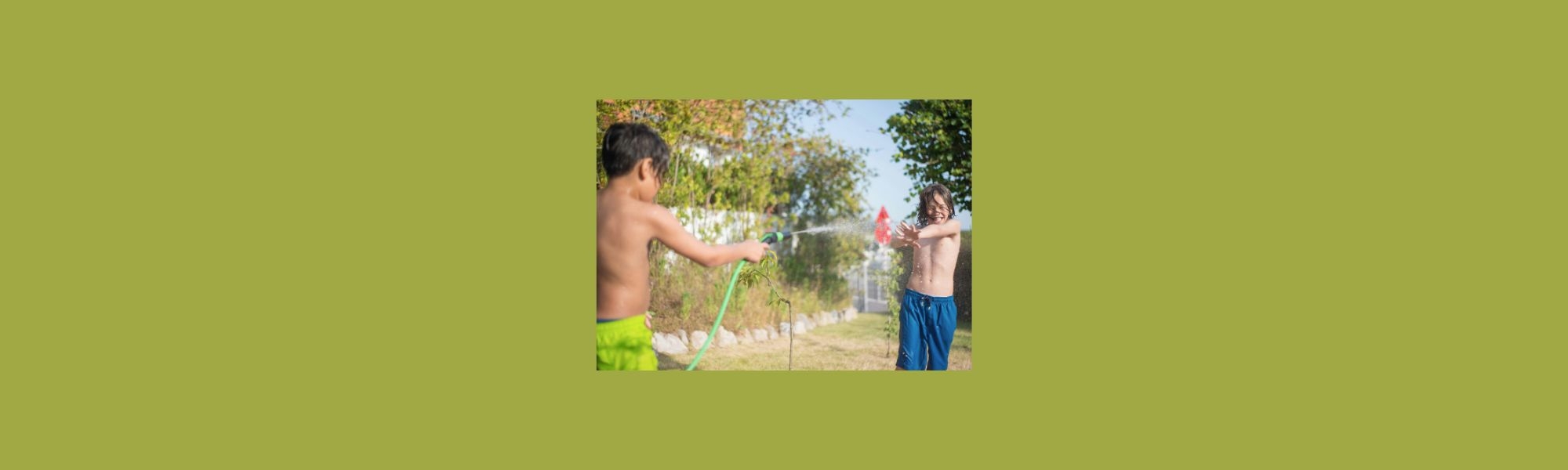 Boys playing with water hose