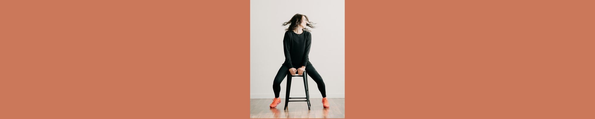 Person sitting on stool doing yoga stretch