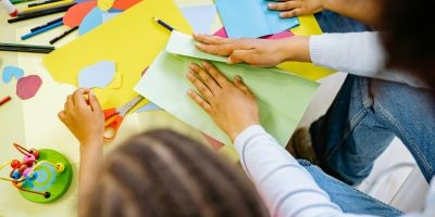 Children making something with construction paper