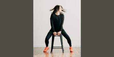 Person on stool doing yoga stretch